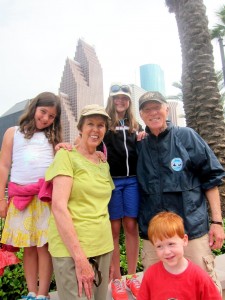 My parents and our kids with the Houston skyline.